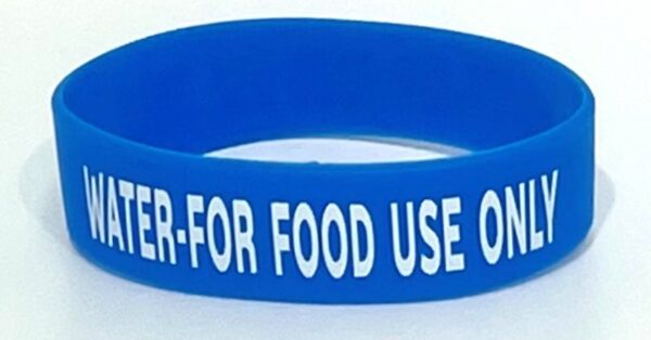 A blue wristband with the words " food use only " written on it.