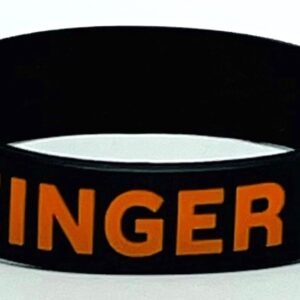 A black and orange wristband with the word " ginger ".