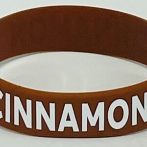 A brown and white cinnamon bracelet with the word cinnamon on it.