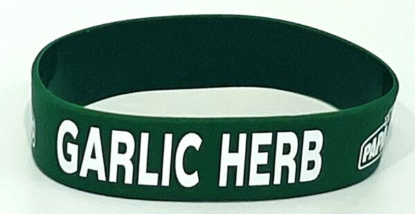 A green bracelet with the words garlic here on it.