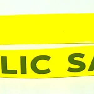 A yellow plastic band with the words public safety written on it.