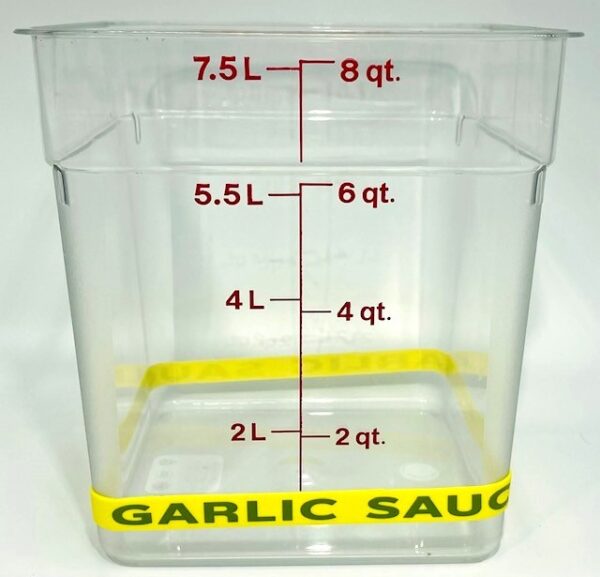 A container with the words garlic sauce written on it.