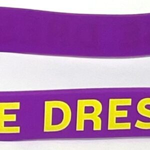 A purple and yellow wristband with the words " free dress ".