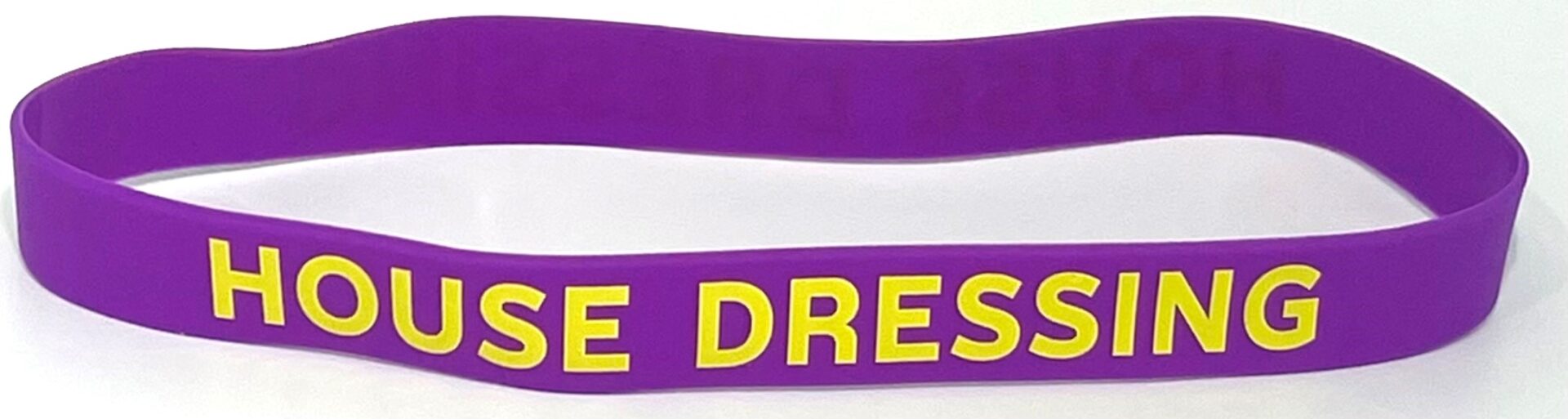 A purple and yellow wristband with the words " free dress ".