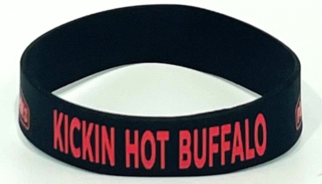 A black wristband with red lettering on it.