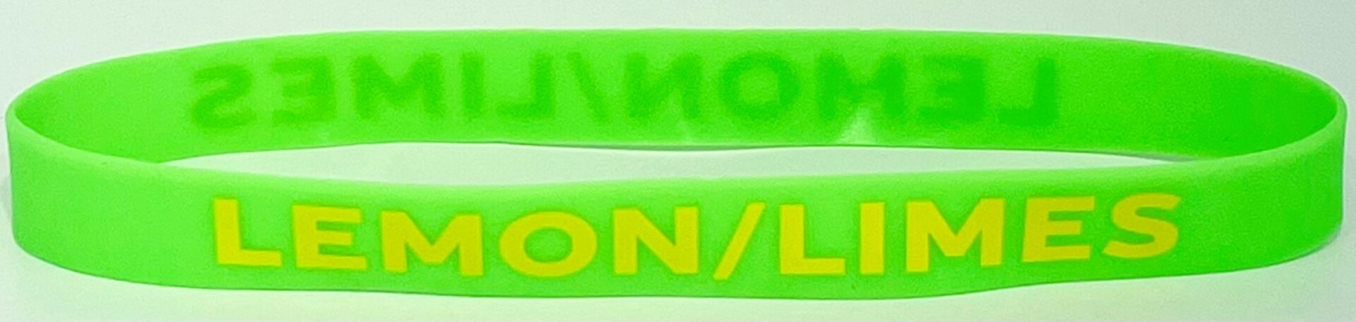 A close up of two green bracelets with yellow lettering