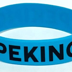 A blue bracelet with the word " peking " written on it.