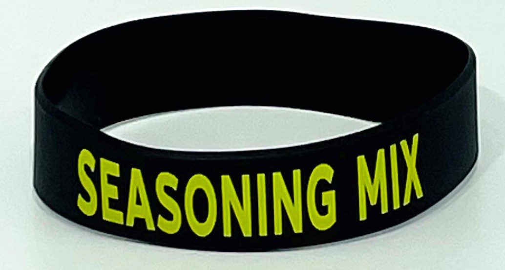 A black and yellow bracelet with the words " reasoning matters ".