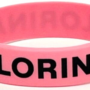 A pink rubber bracelet with the word " coloring " written on it.