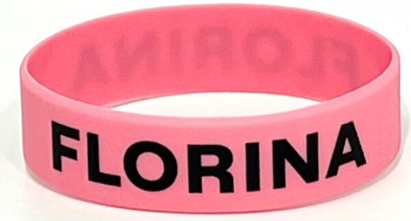 A pink rubber bracelet with the word " coloring " written on it.