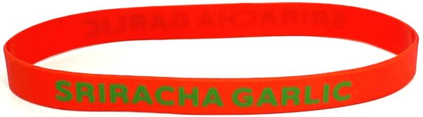 A red bracelet with the word " cha ga ga ".