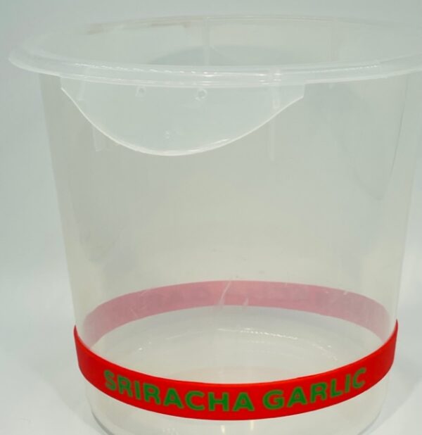 A plastic container with a red band around it.