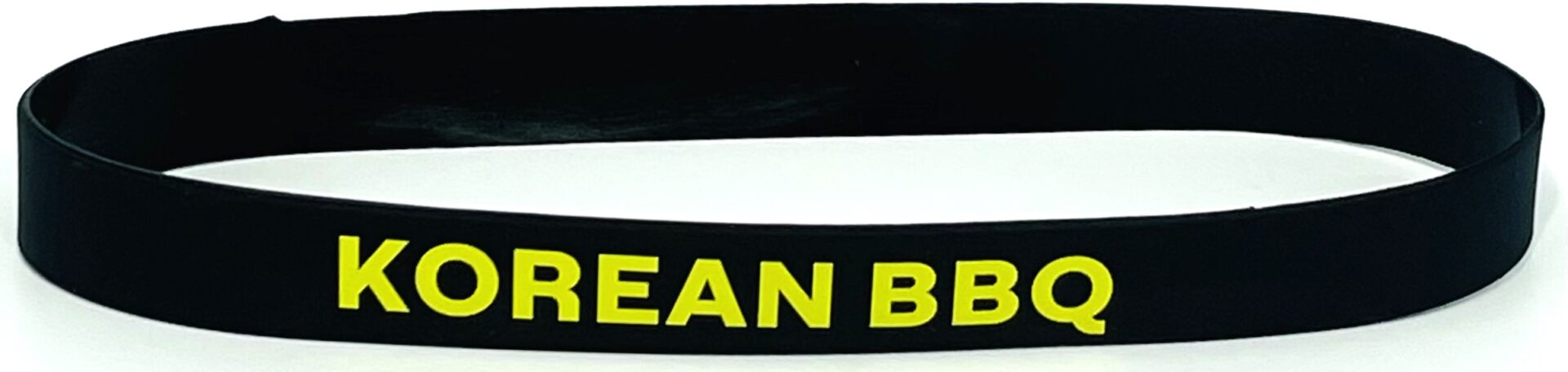 A black headband with yellow letters on it.