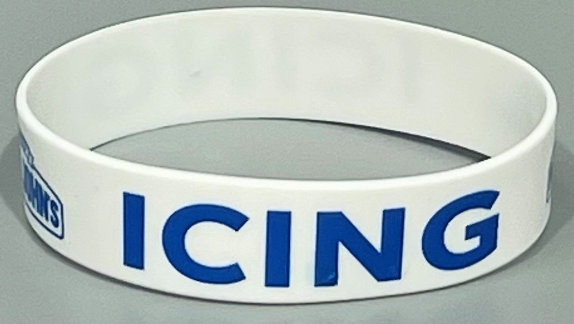 A white and blue wristband with the word " racing ".