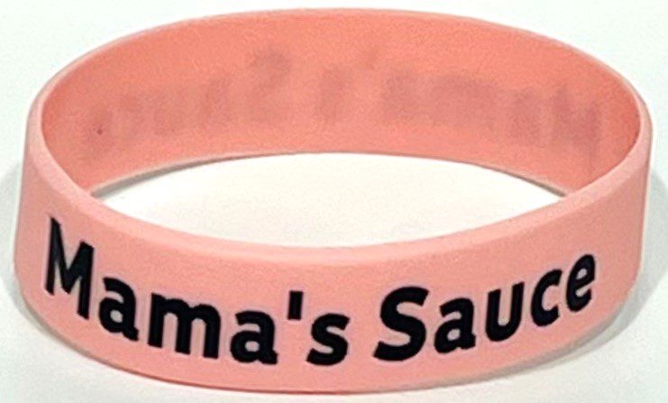 A pink bracelet with the name mama 's sauce written on it.