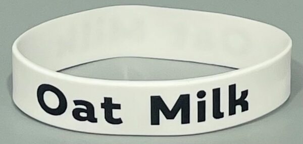 A white bracelet with the words " eat milk ".