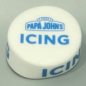 A white and blue icing container sitting on top of a table.