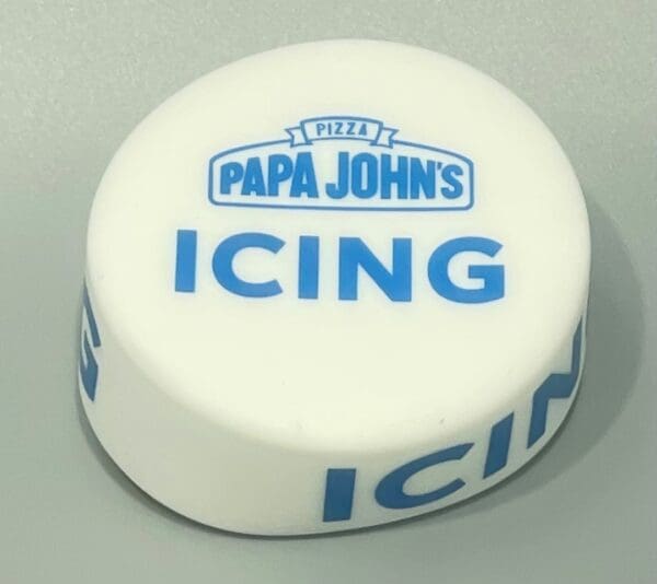 A white and blue icing container sitting on top of a table.