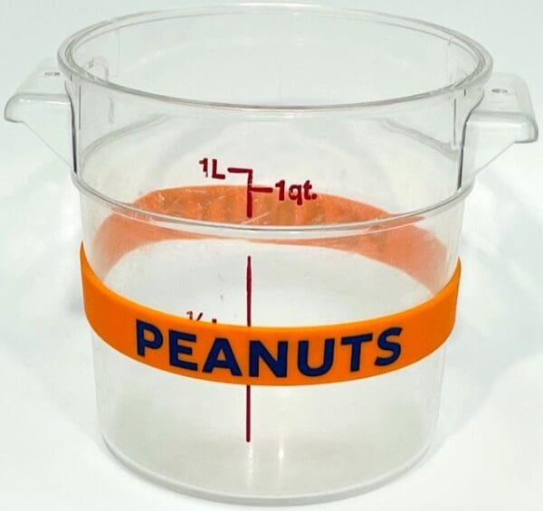 A plastic cup with peanuts written on it.