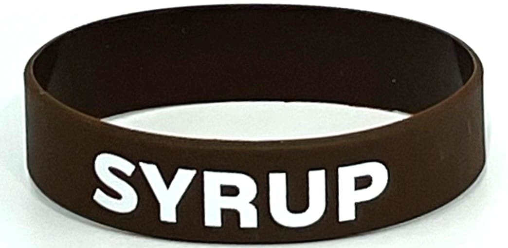 A brown and white bracelet with the word syrup written on it.