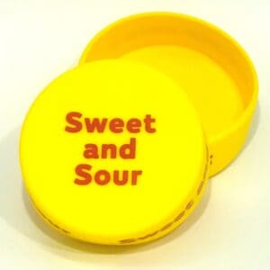 A yellow container with the words " sweet and sour ".