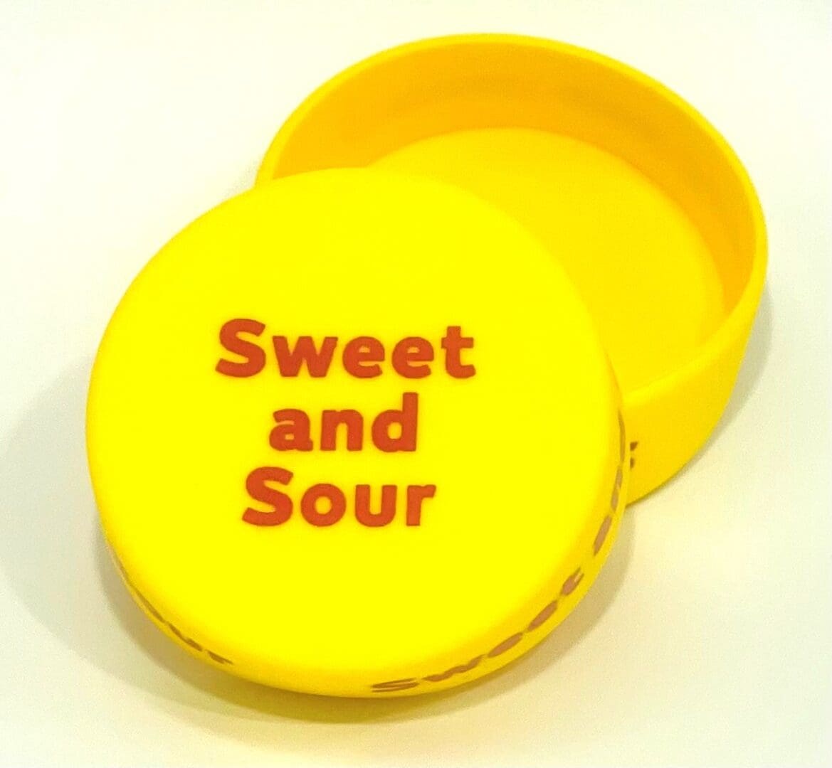 A yellow container with the words " sweet and sour ".