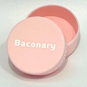 A pink round box with the words " baconary ".