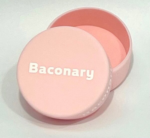 A pink round box with the words " baconary ".