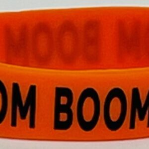 A neon orange rubber bracelet with the words boom boomin on it.