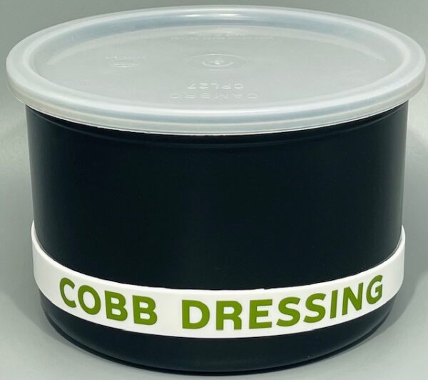 A black container with cobb dressing written on it.