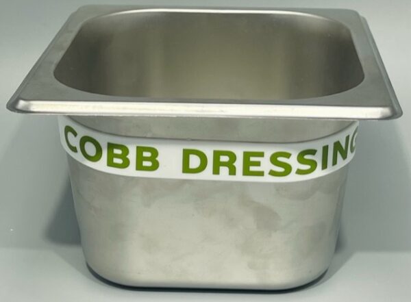 A metal bowl with cobb dressing written on it.