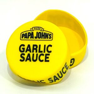 A yellow container with the word " papa johns garlic sauce ".