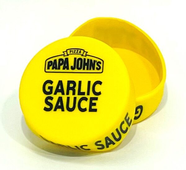 A yellow container with the word " papa johns garlic sauce ".