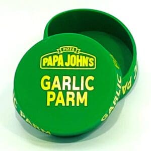 A green box with the words papa johns garlic parm on it.