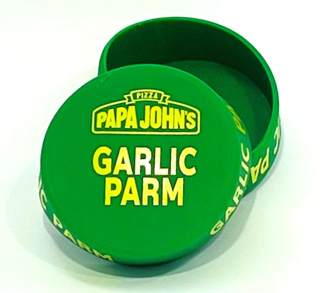 A green box with the words papa johns garlic parm on it.