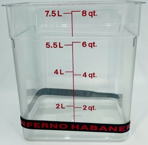 A clear container with red lettering and black handle.