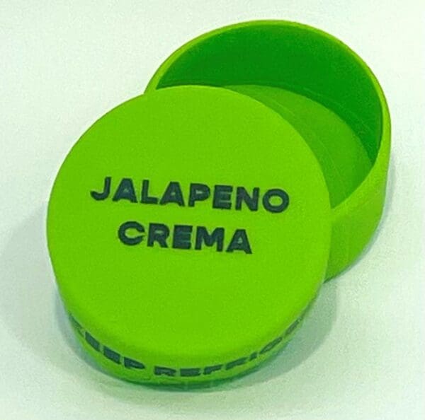 A green container with the words jalapeno crema on it.