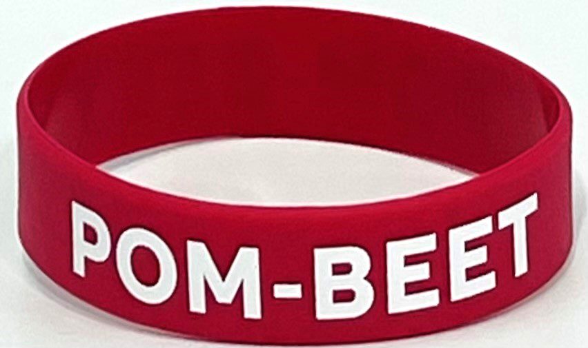 A red bracelet with the word " tom-bee ".