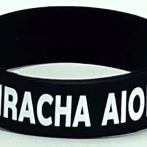A black and white wristband with the name of miracha aiolos.