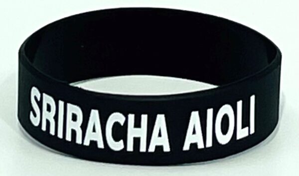 A black and white wristband with the name of miracha aiolos.