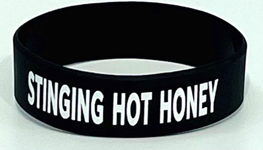 A black and white wristband with the words " banging hot honey ".