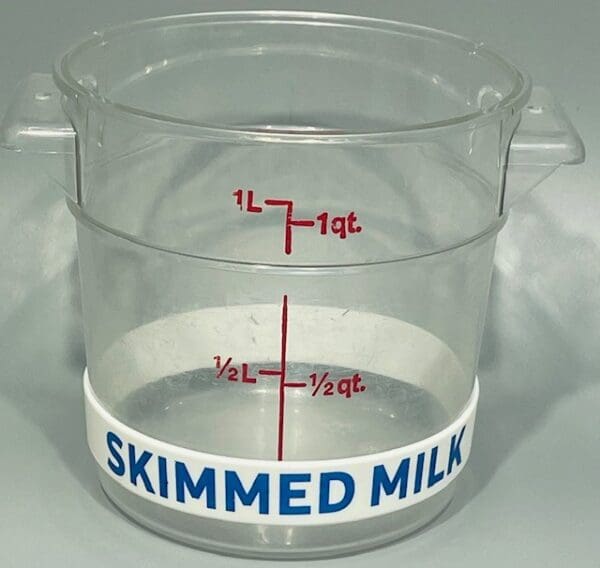 A plastic container with the words " skimmed milk ".