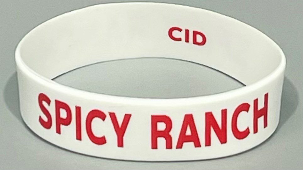 A white and red bracelet with the words spicy ranch written on it.