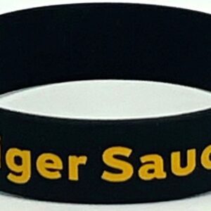 A black and yellow wristband with the words tiger sauce written on it.