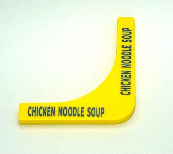 A yellow noodle sign with the words chicken noodle soup written on it.