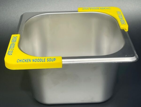 A metal container with yellow labels on it.