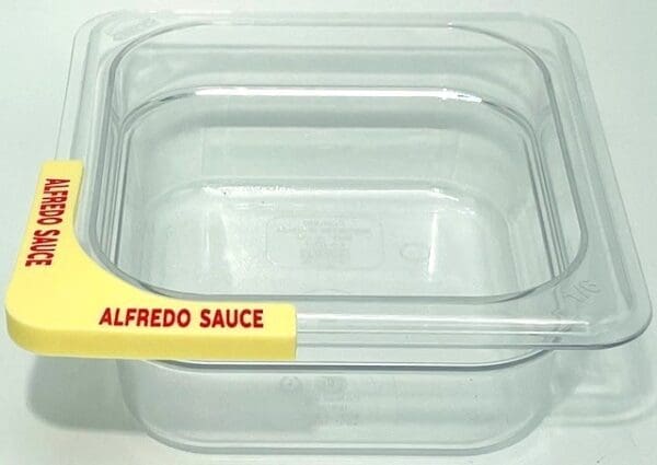 A plastic container with alfredo sauce on it.