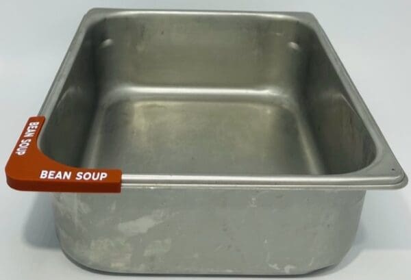 A metal pan with the name " soup ".