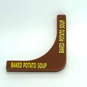 A brown plastic wedge shaped sign with baked potato soup written on it.