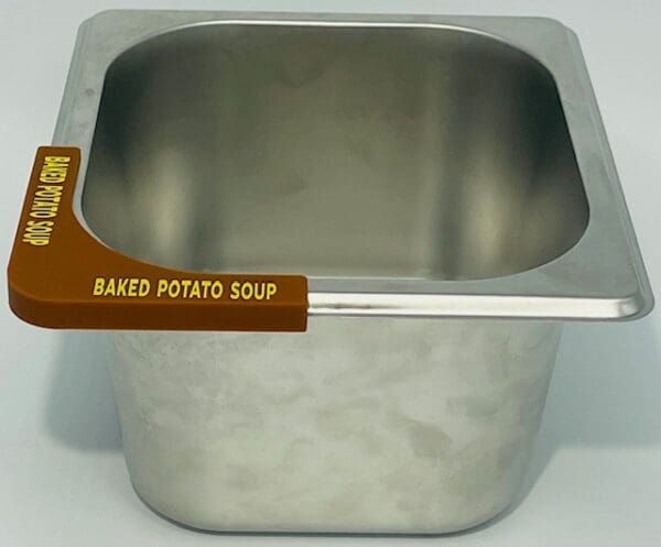 A metal bowl with the label baked potato soup.